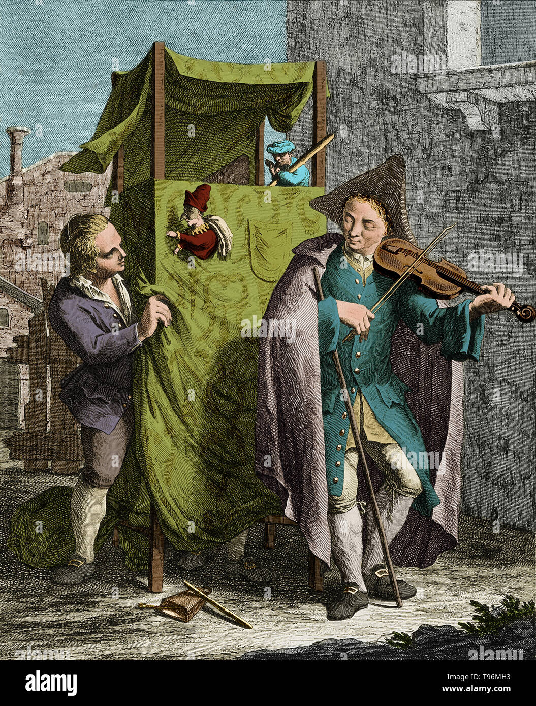 A young man plays a violin in front of a Punch and Judy stand while a puppeteer, who usually hides underneath the stand, manipulates the puppet. The hat and feet of  second puppeteer can be seen hiding behind the curtain. Engraving by Giovanni Volpato after Francesco Maggiotto, c. late 18th century. Stock Photo