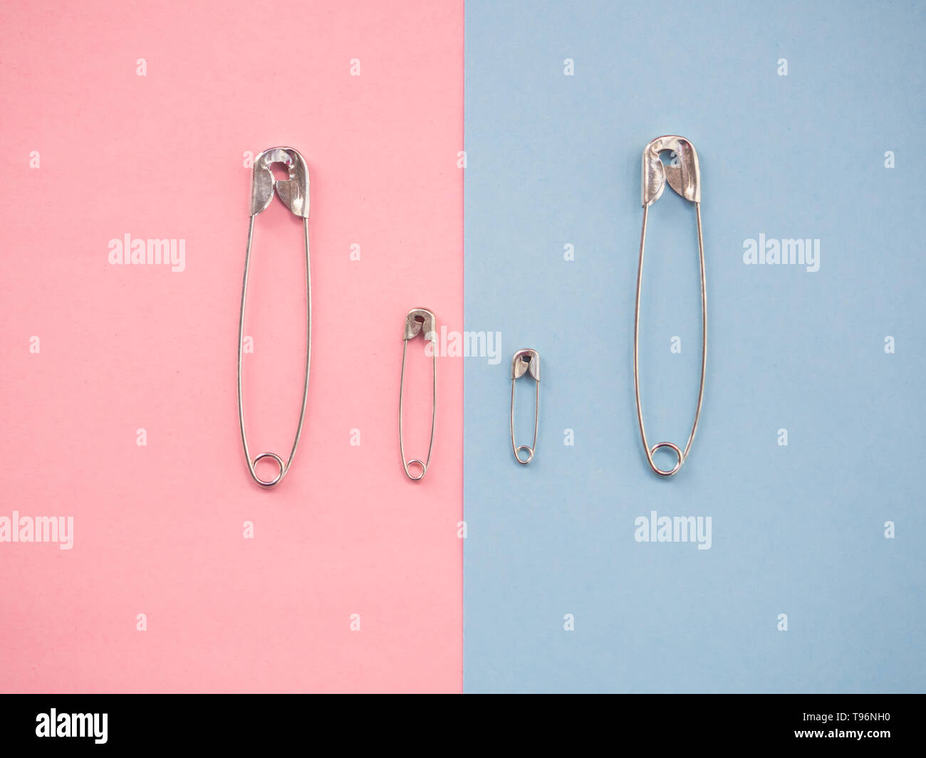 Several safety pins of various sizes in human representation. Concept of traditional family with children Stock Photo