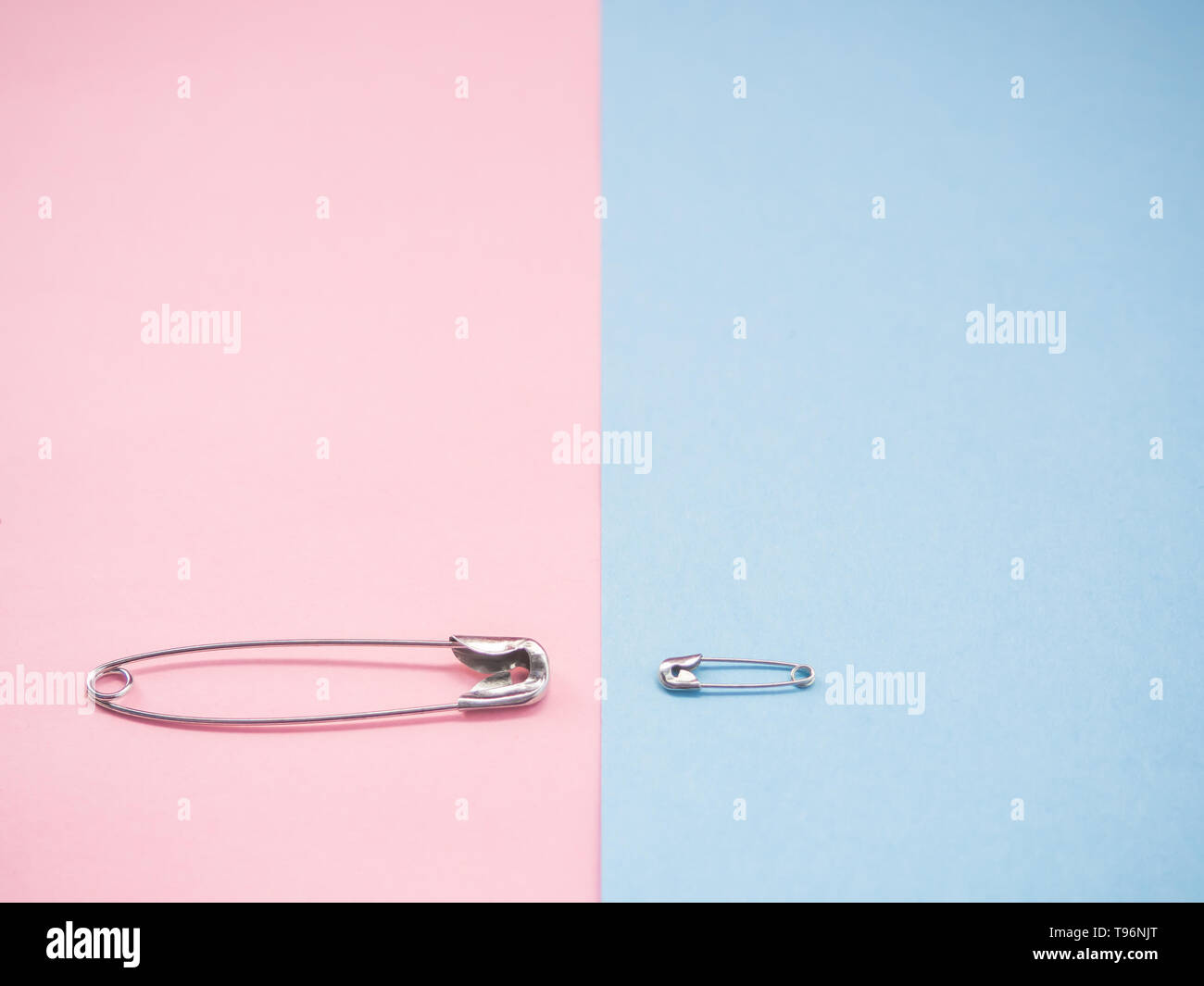 Two safety pins representing a man and a woman. Concept of machismo and feminism Stock Photo
