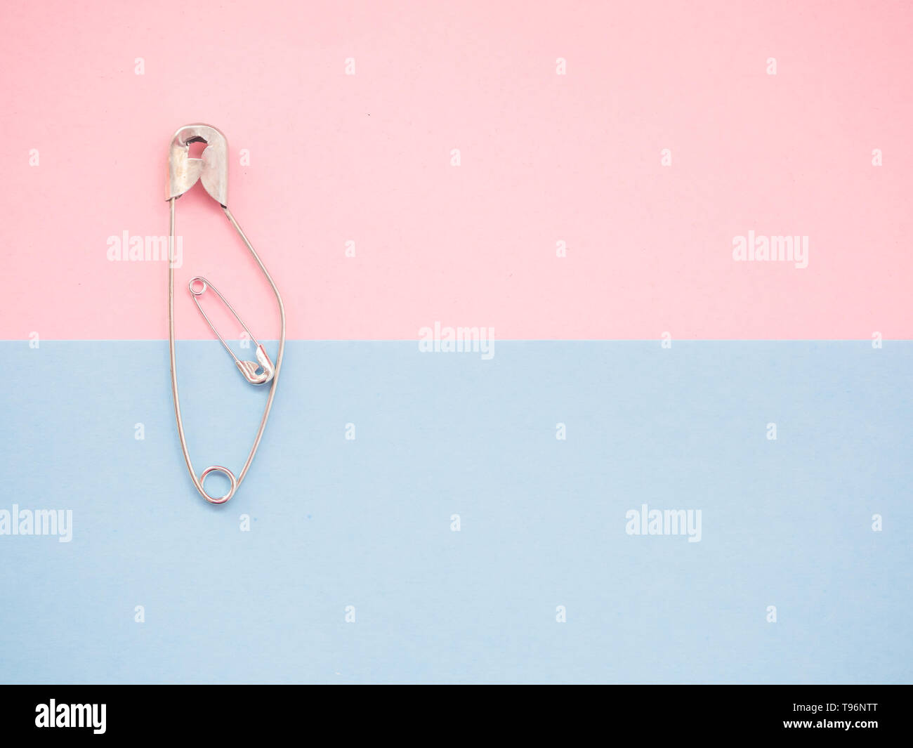 A safety pin representing a pregnant woman with a baby Stock Photo Alamy
