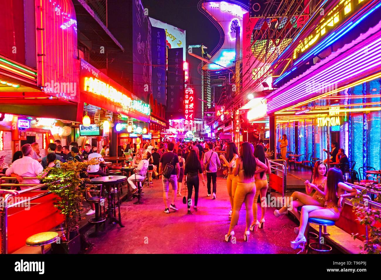 Nightlife, Soi Cowboy Red Light District, girls standing outside bar, Asoke Road, Sukhumvit, Bangkok, Thailand Stock Photo