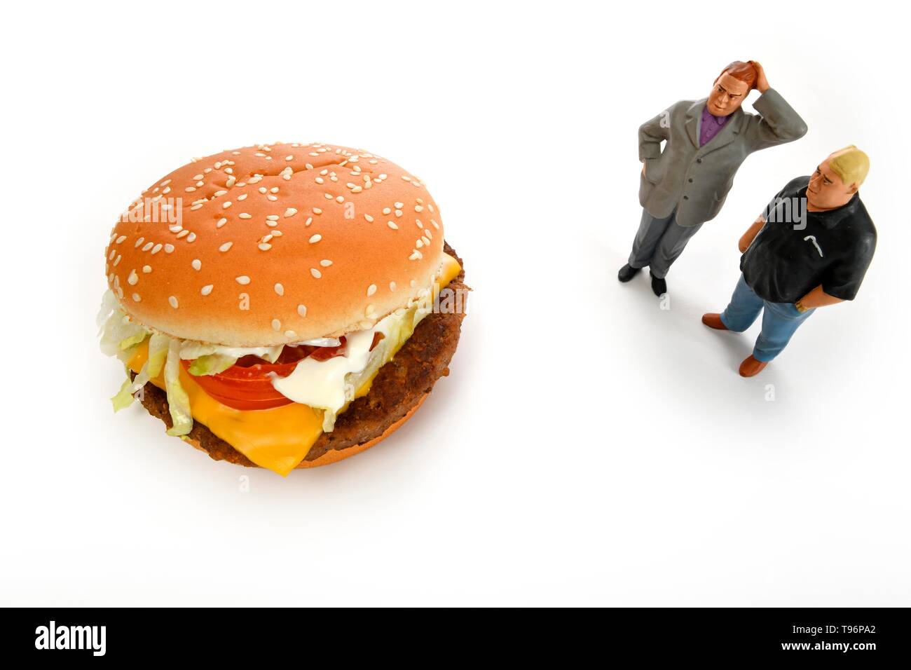 Symbol picture overweight, unhealthy diet, thoughtful figures in front of Cheeseburger, Germany Stock Photo
