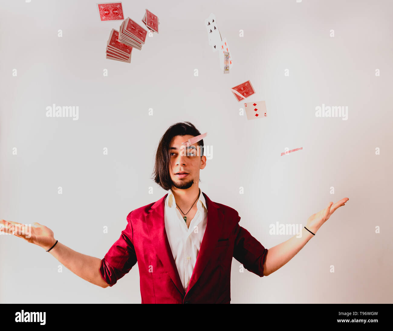 Young magician juggling a deck of playing cards Stock Photo Alamy