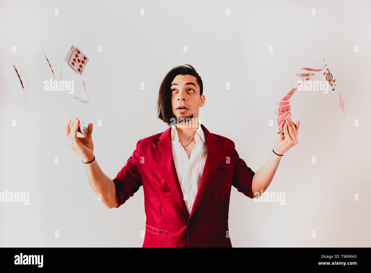 Young magician juggling a deck of playing cards Stock Photo Alamy