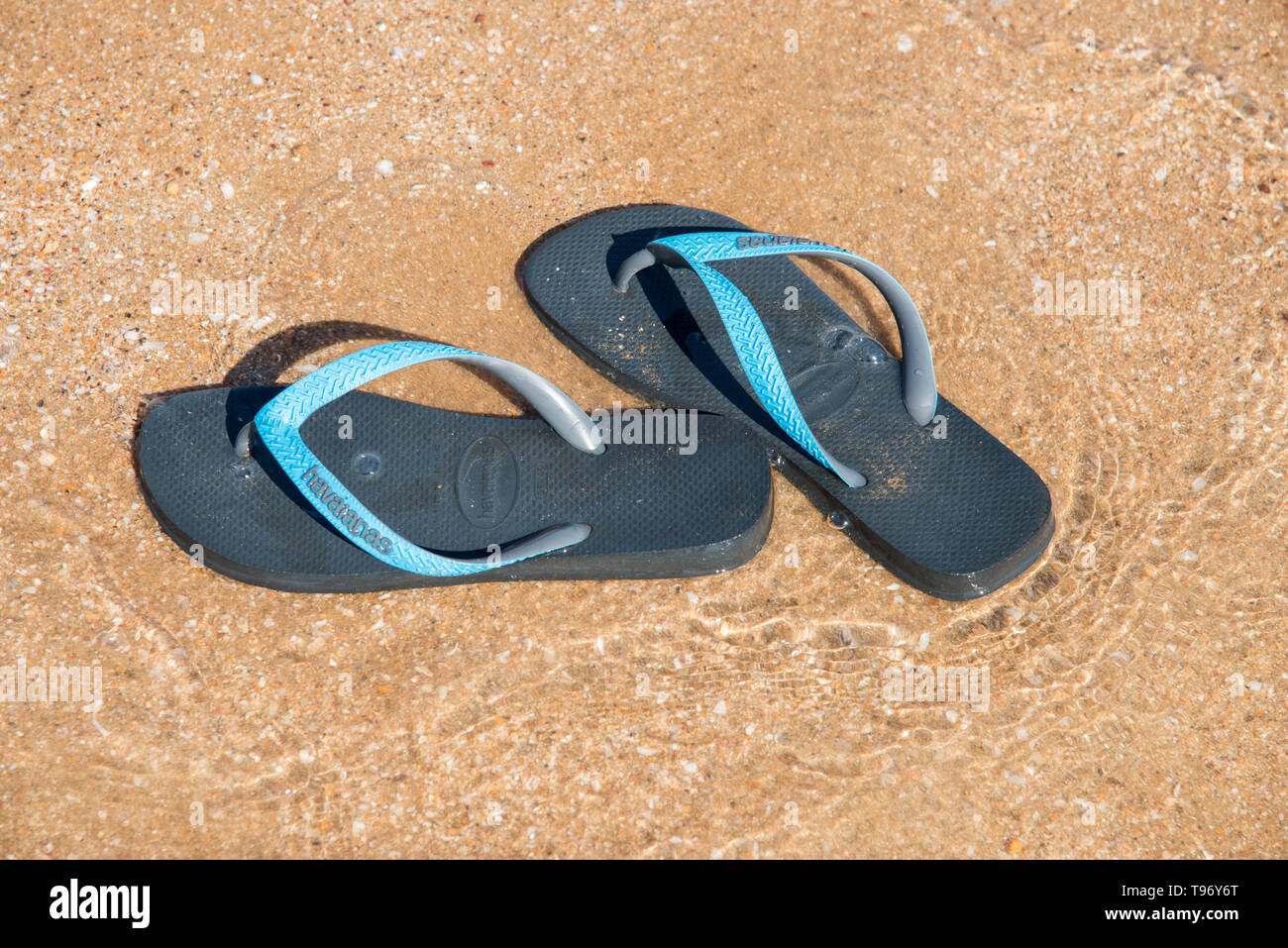 Darwin, Northern Territory, Australia-July 22,2018: High angle view over abandoned Havaianas thongs on the shore at Mindil Beach in Darwin, Australia Stock Photo