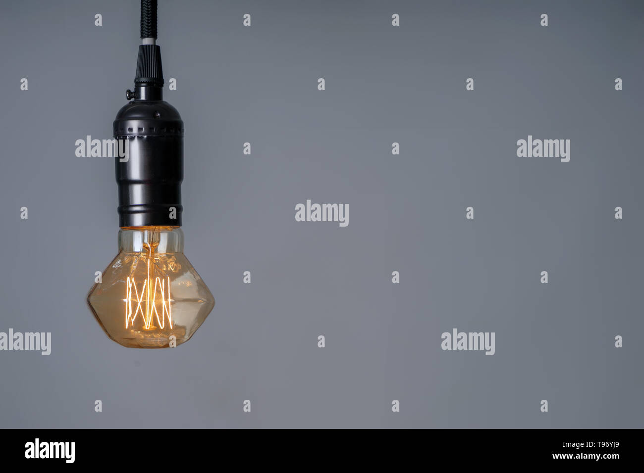 Retro light bulb on grey background Stock Photo