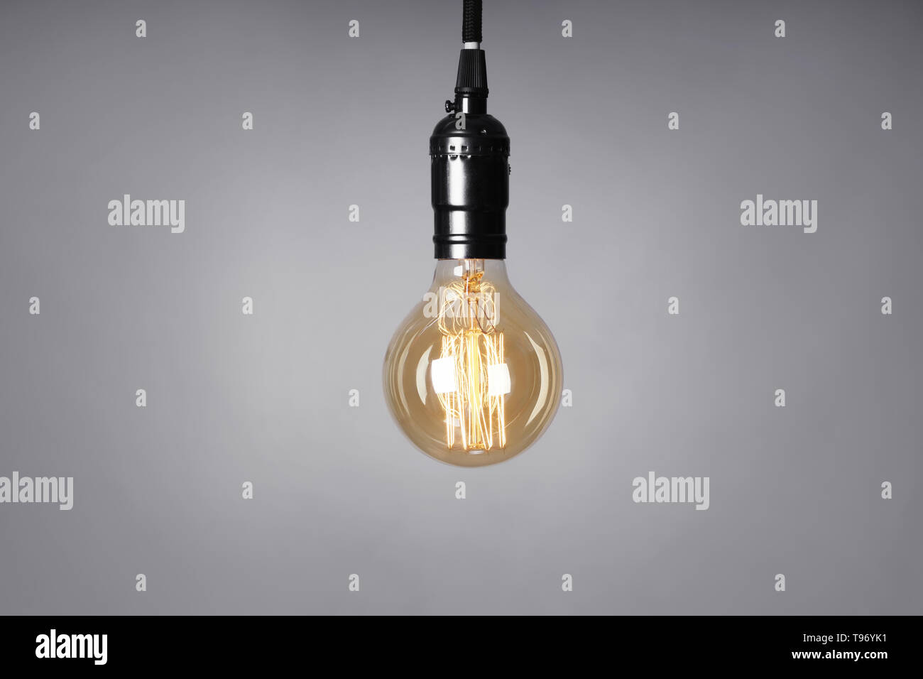 Retro light bulb on grey background Stock Photo