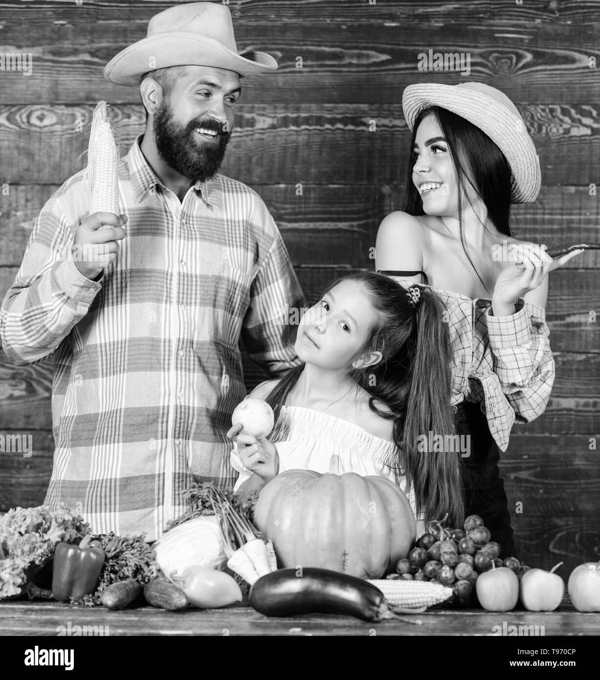 Parents and daughter celebrate autumn harvest festival. Family rustic