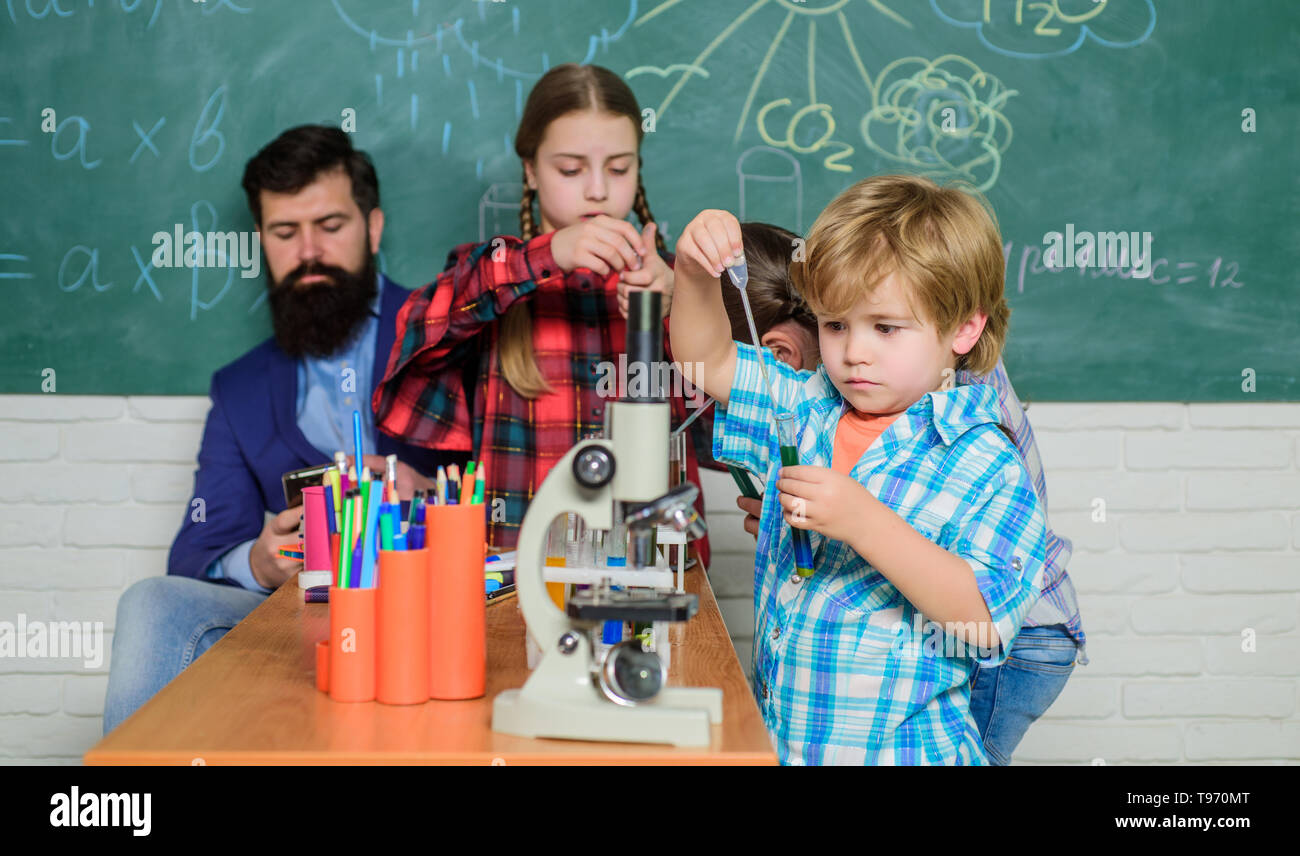 School chemistry laboratory. back to school. Educational concept. Pupils in the chemistry class. happy children teacher. children scientists making experiments in laboratory. Stock Photo