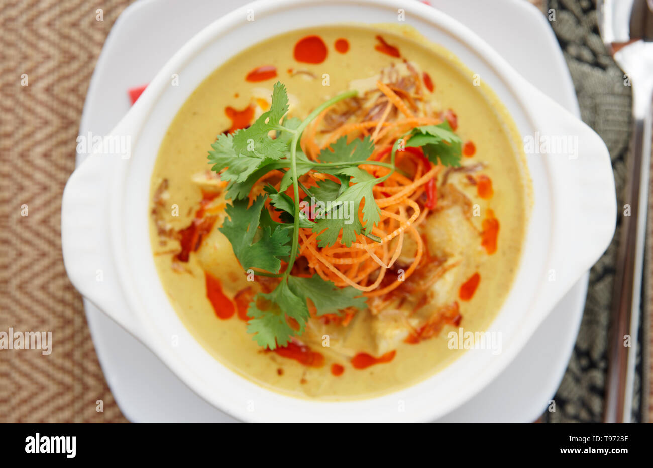 Bowl of Tom Yam spicy curry dish, Thai cuisine Stock Photo