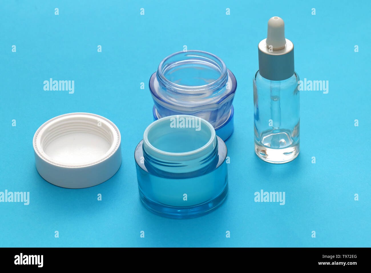 Download Cosmetics And Face Serums In Glass Jars On Blue Background Stock Photo Alamy Yellowimages Mockups