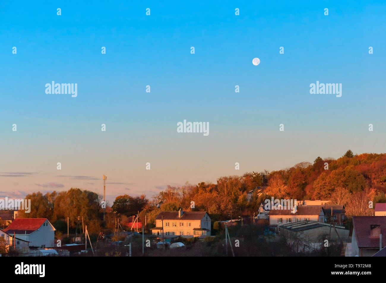 dawn and the moon in the sky, the dawn hours in the village in the spring Stock Photo