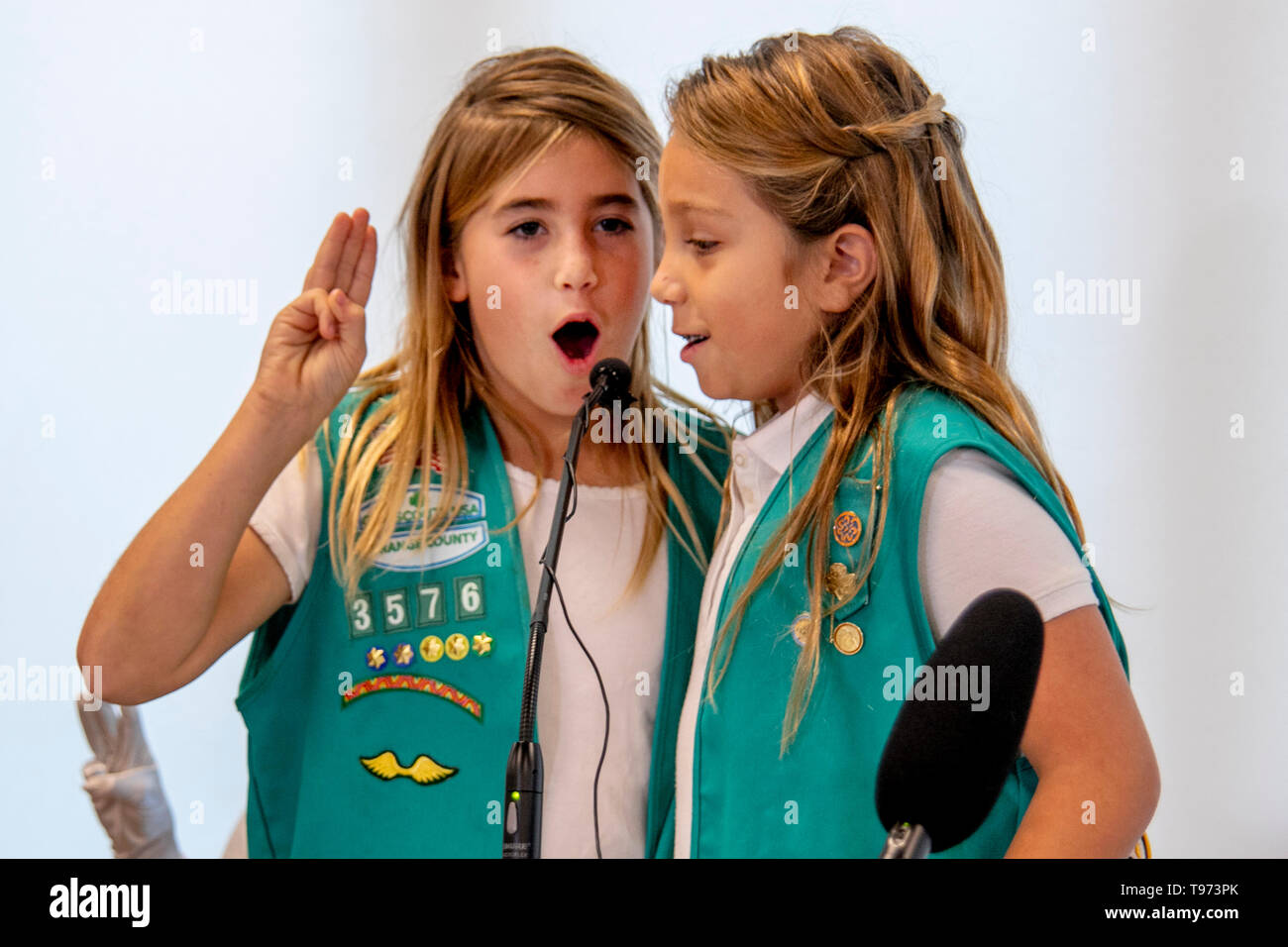 Two uniformed Girl Scouts recite the Girl Scout Oath at the dedication