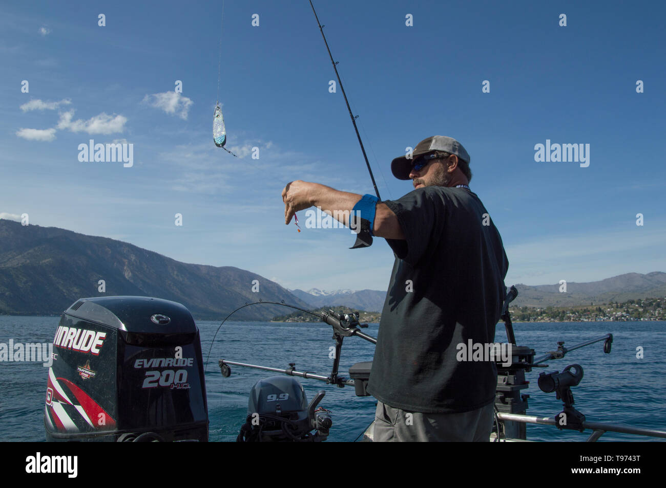 Fisherman with fishing rod rigged with a flasher and spoon fishing for Kokanee  salmon on Lake Chelan,Washington State, USA Stock Photo - Alamy