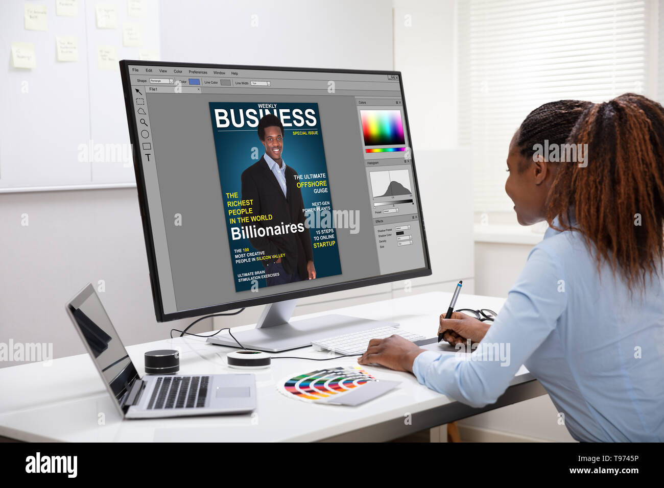 Young Female Designer Editing Photos On Computer In Office Stock Photo