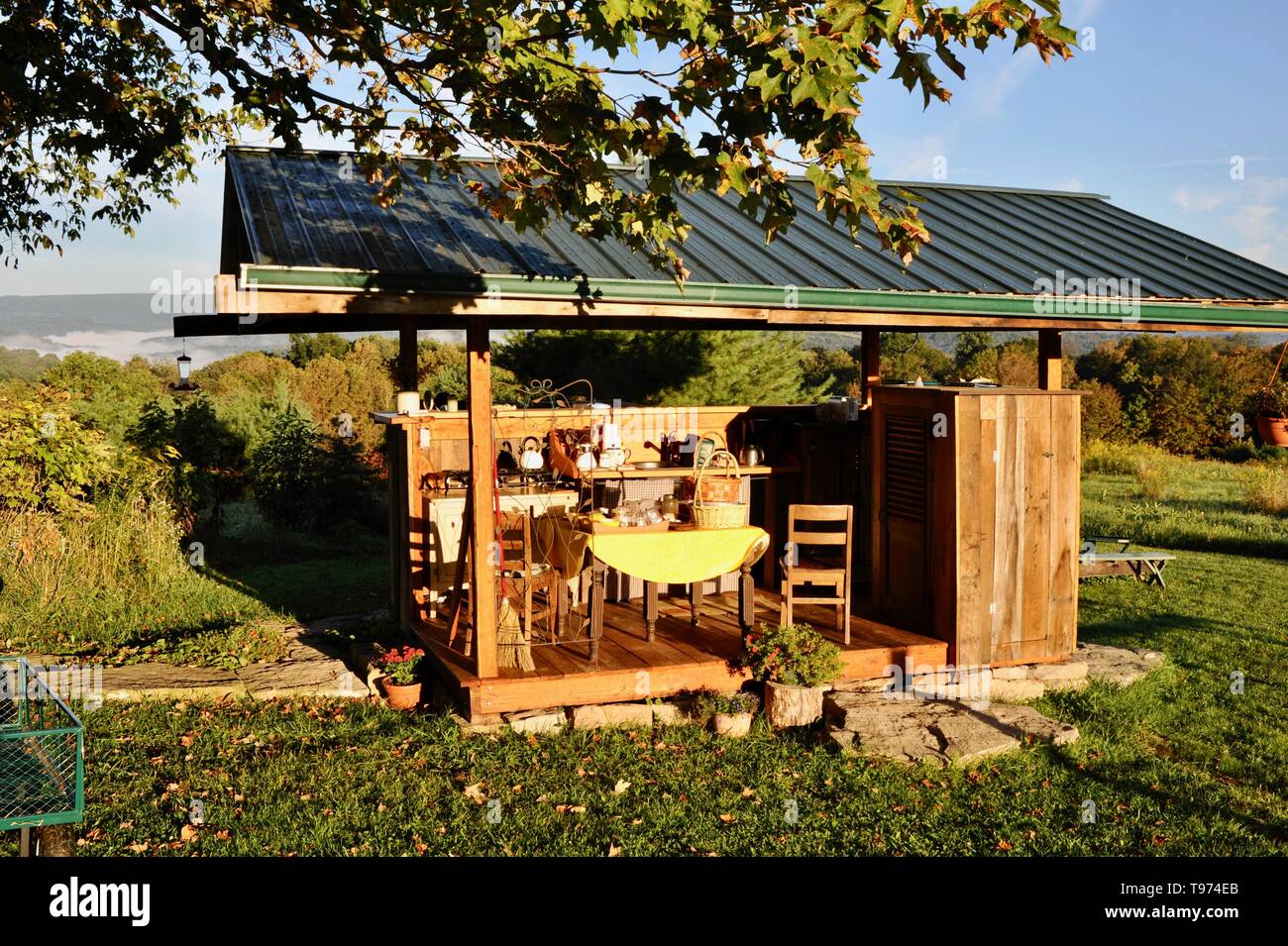 Outdoor kitchen facilities, stove, table, pans and pots, for 'glamping' (glamorous camping) experience at Campbell Farm, Fort Hill, Pennsylvania USA Stock Photo