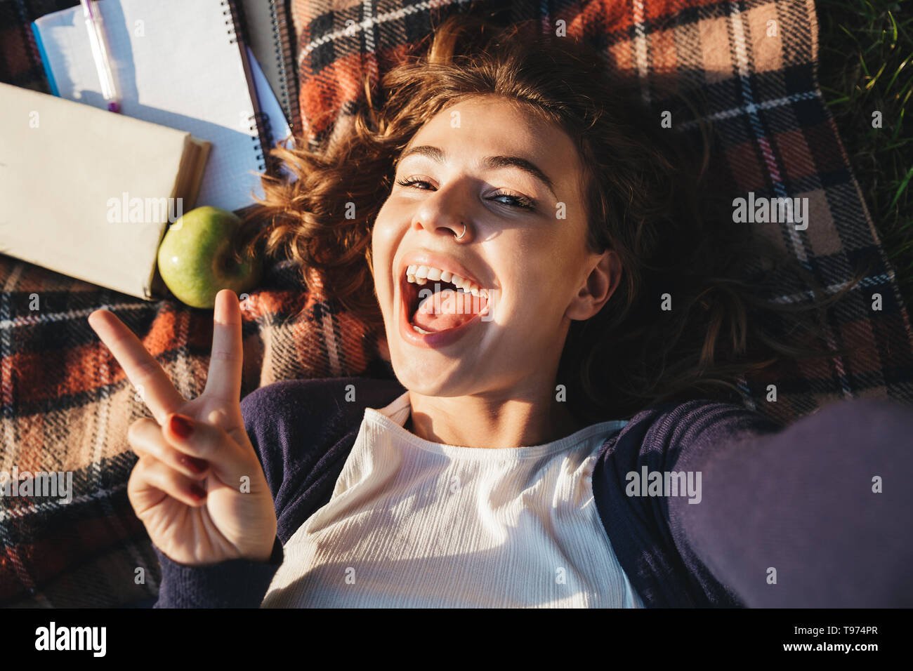 top-view-of-a-lovely-young-teenage-girl-laying-on-a-blanket-at-the-park