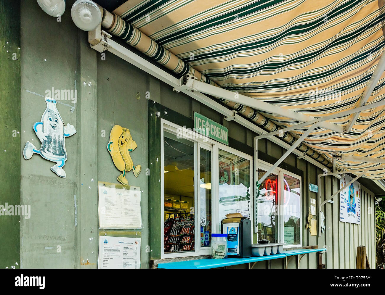 A striped awning and retro signs decorate the exterior of Billy Goat Concessions, also called BGH Cafe, Feb. 3, 2018, in Dauphin Island, Alabama. Stock Photo
