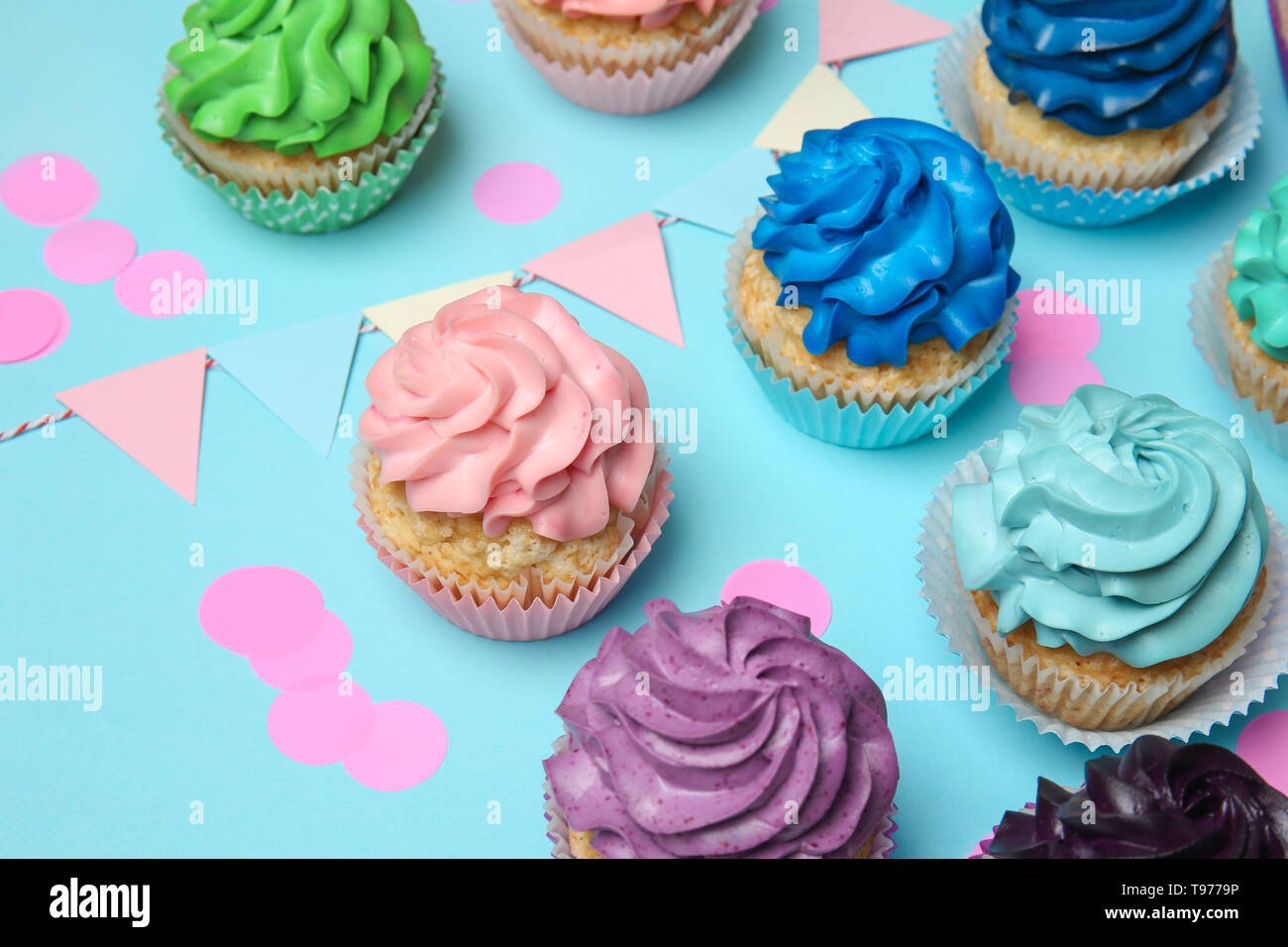 Different cupcakes on color background Stock Photo