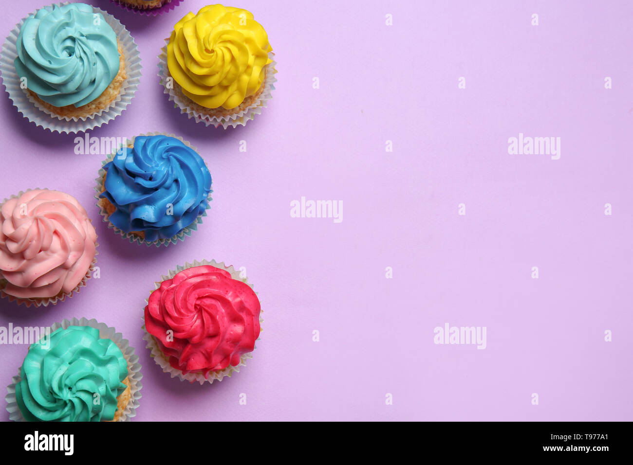 Different cupcakes on color background Stock Photo