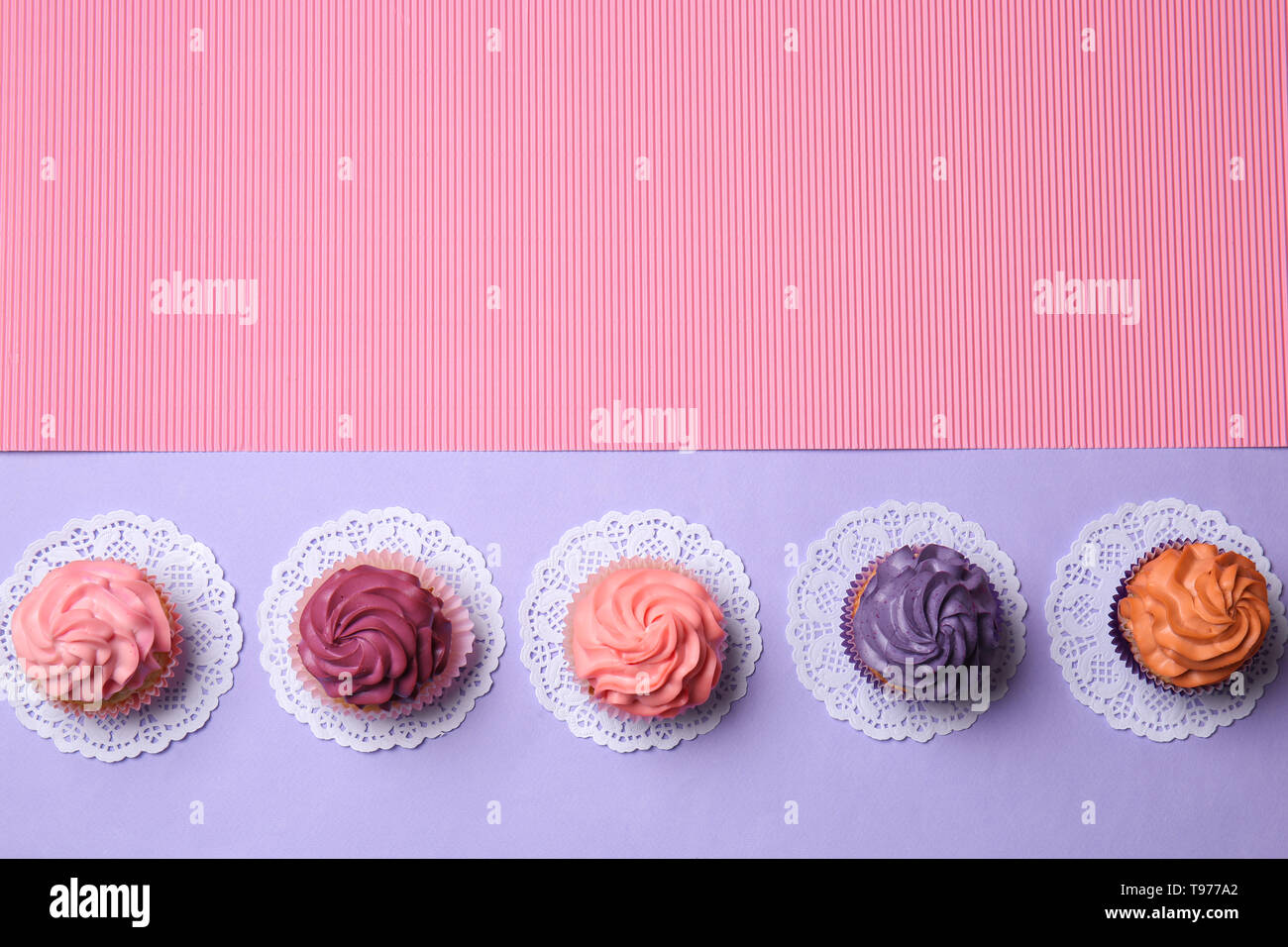 Different cupcakes on color background Stock Photo