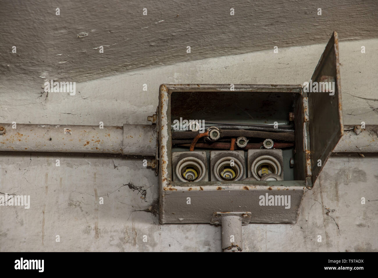 old electrical boxes on wall Stock Photo