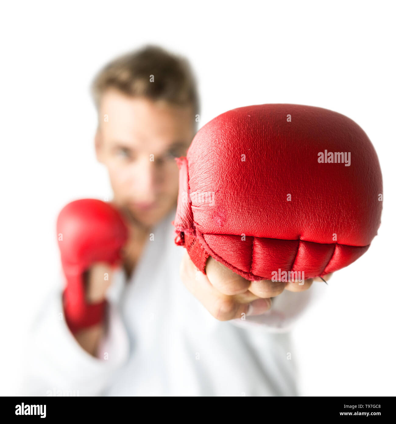 Kick boxer with red boxing gloves performing a martial arts punch
