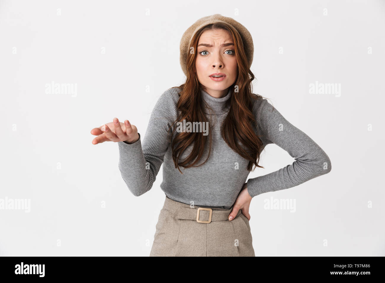 Portrait of perplexed woman 30s wearing hat gesturing and asking ...