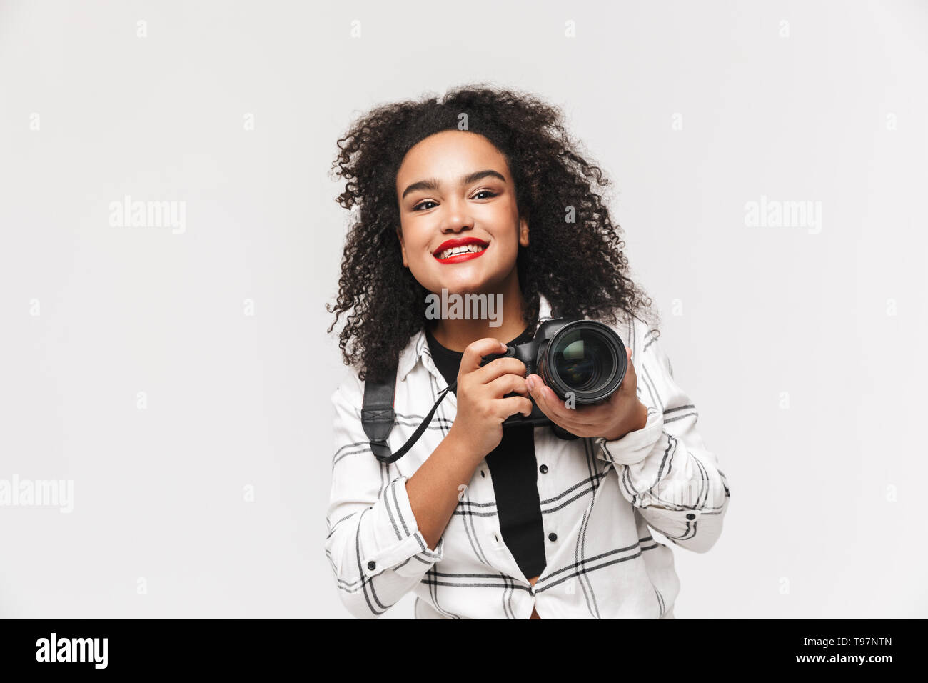Portrait of a cheerful afro american woman standing isolated over white ...
