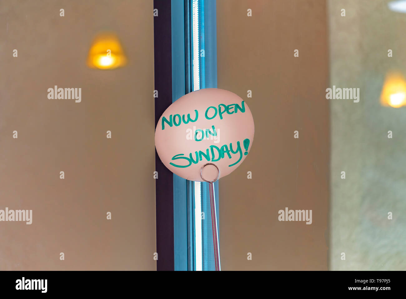 Close up view of a handwritten sign that reads Now Open On Sunday Stock ...