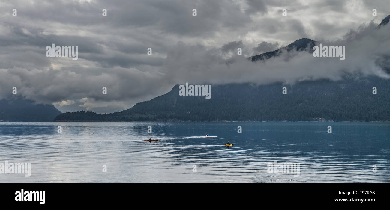 Clouds near the ground in the mountains near a lake, on a cloudy day of ...