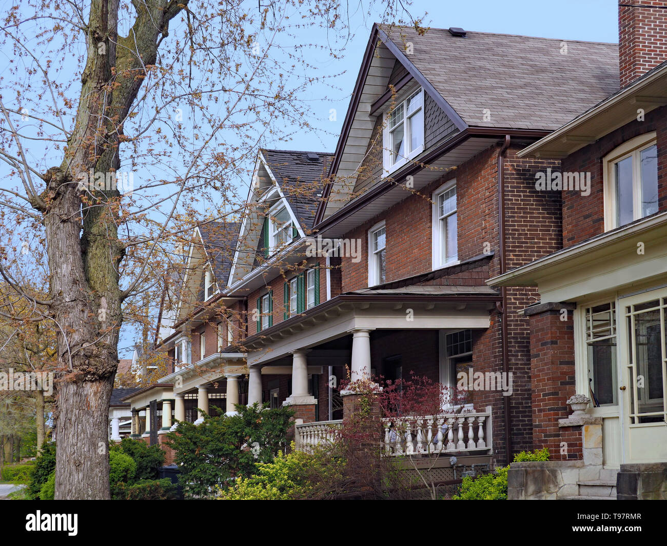 row of old urban houses with gables and large porches Stock Photo - Alamy