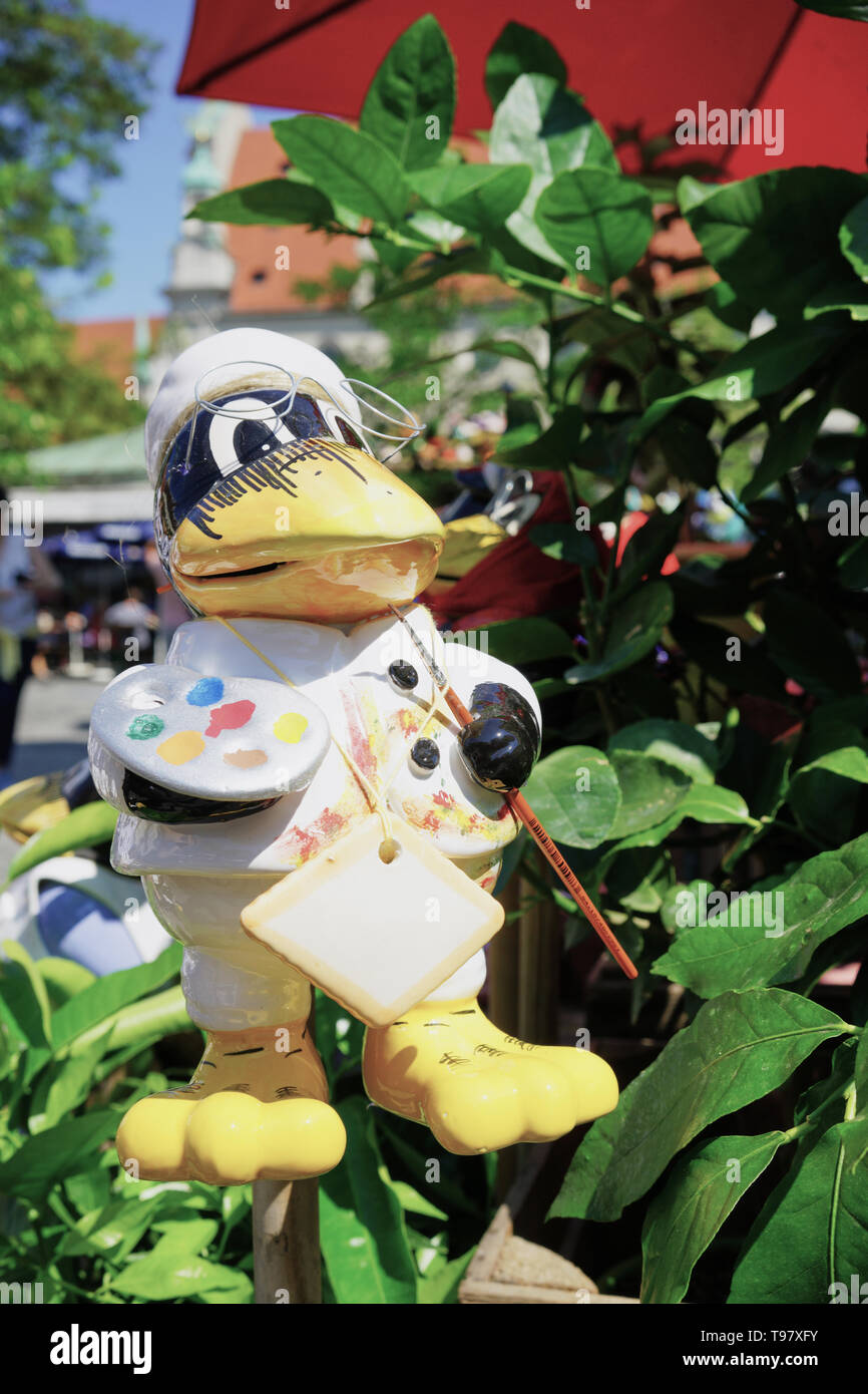 Porcelain 'Artist Duck' lawn ornament with paint brush and palette Stock Photo