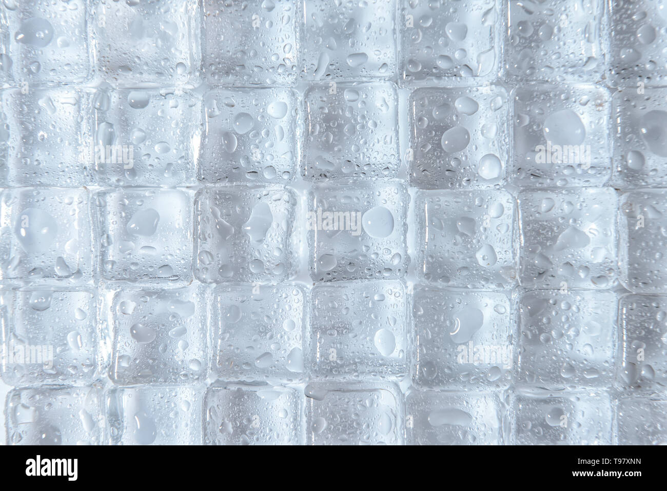 Transparent ice cubes on white background Stock Photo - Alamy