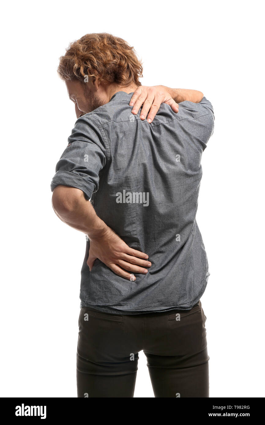 Young man suffering from back pain on white background Stock Photo - Alamy