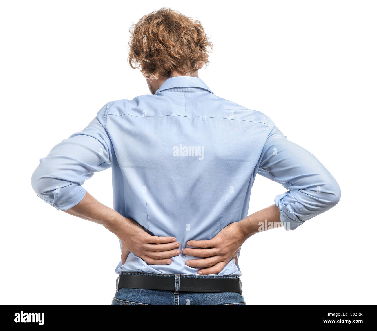 Young man suffering from back pain on white background Stock Photo - Alamy