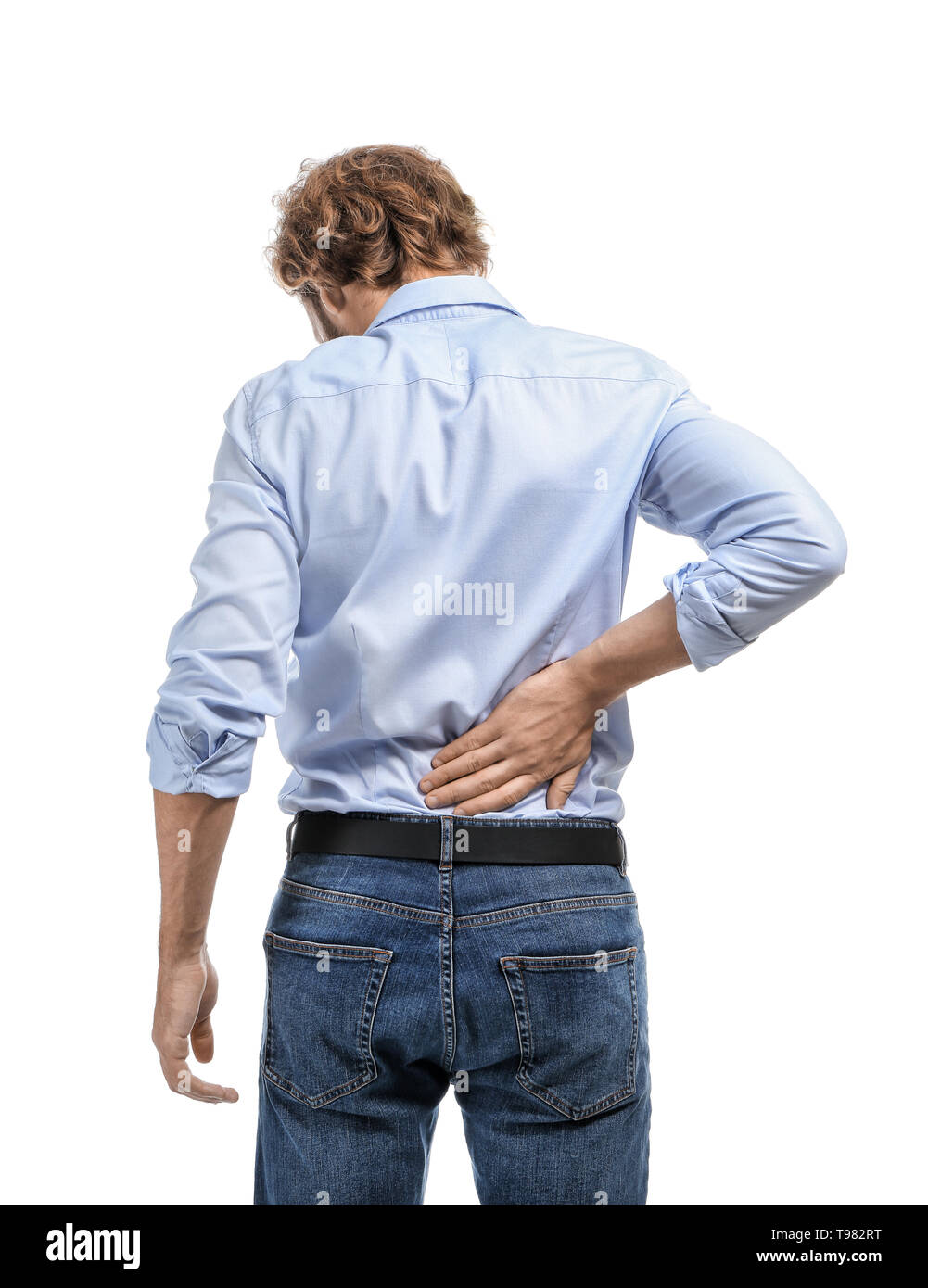 Young man suffering from back pain on white background Stock Photo - Alamy