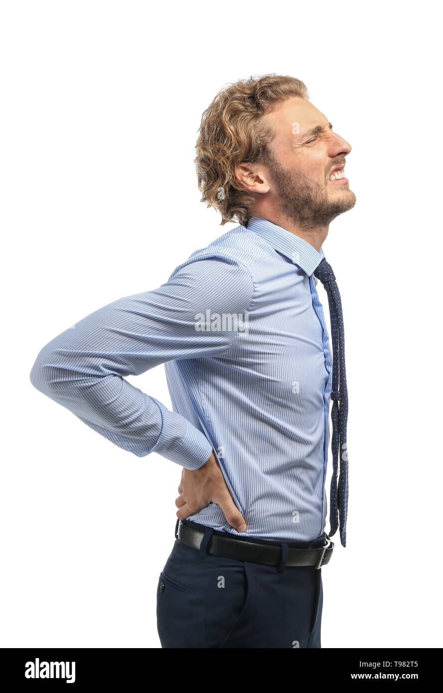 Young man suffering from back pain on white background Stock Photo - Alamy