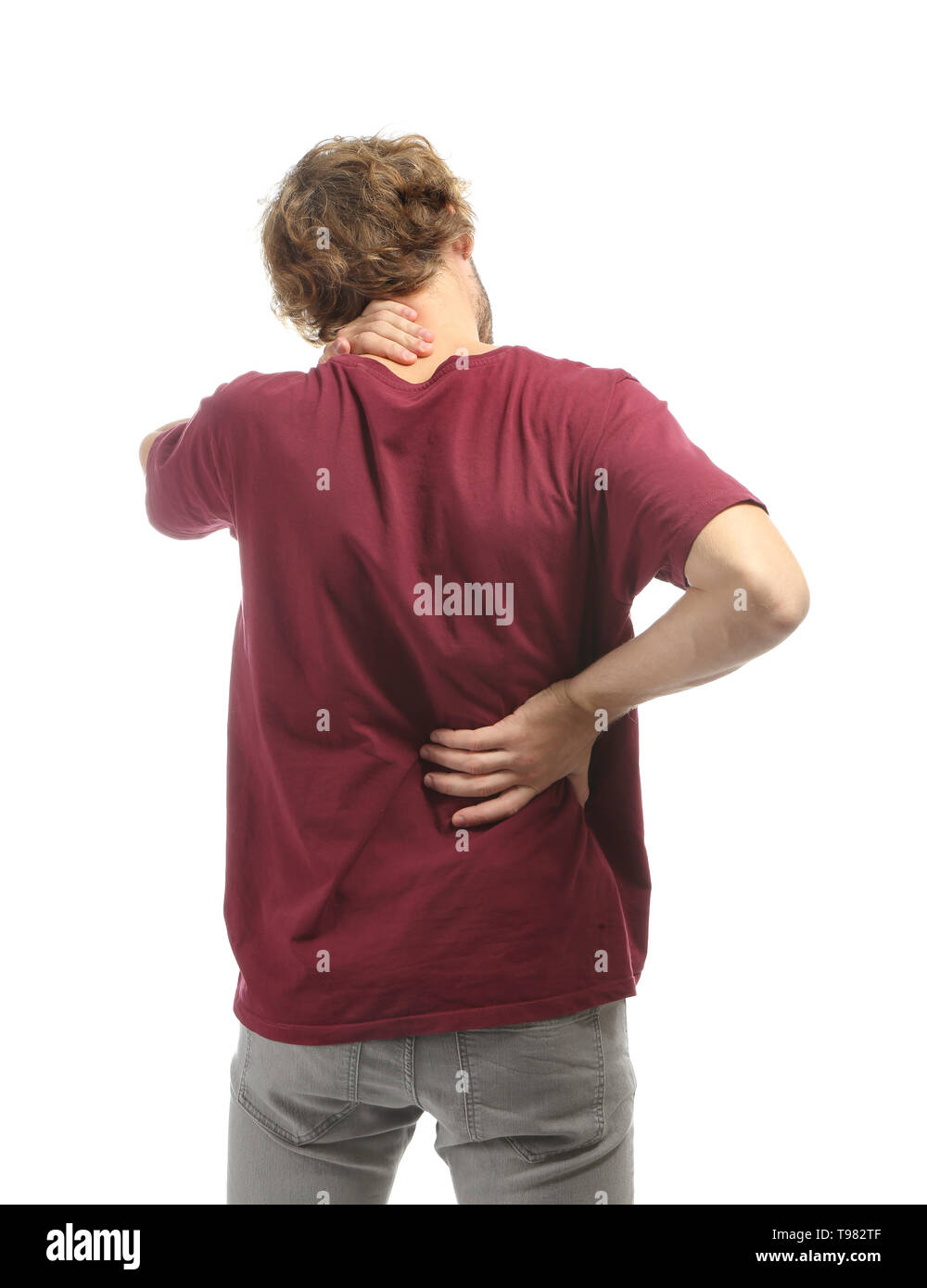 Young man suffering from back pain on white background Stock Photo - Alamy