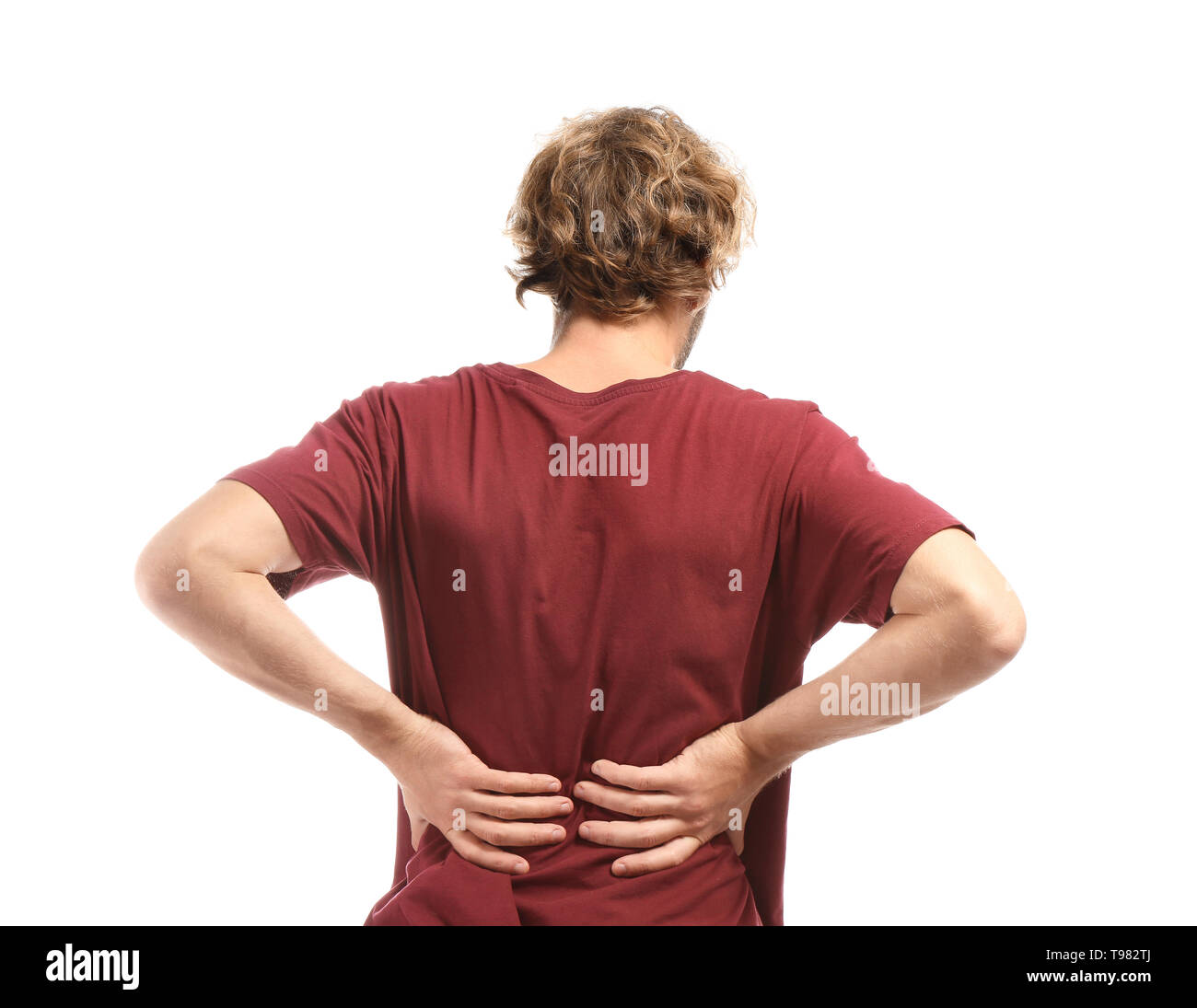 Young man suffering from back pain on white background Stock Photo - Alamy