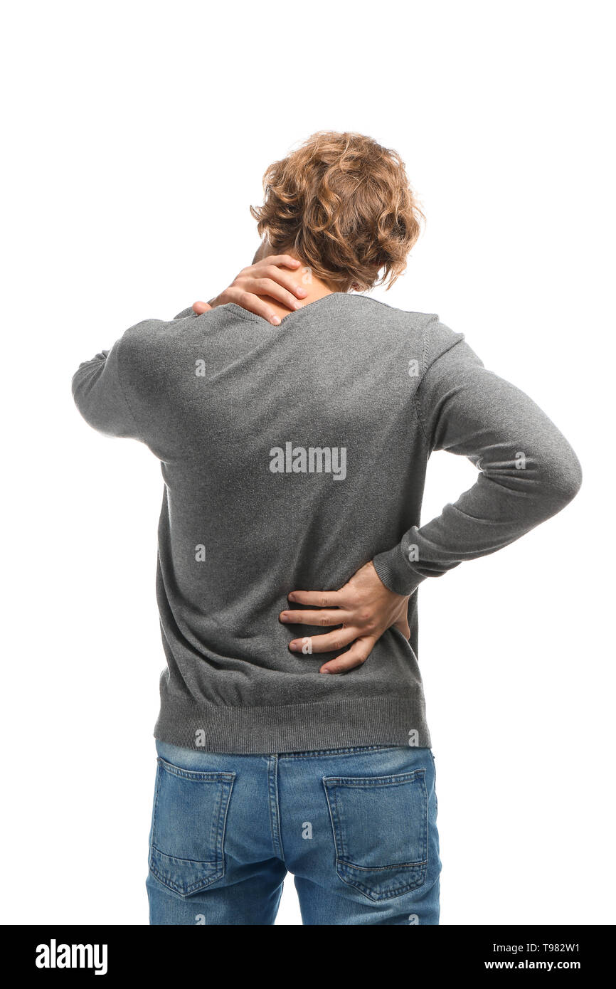 Young man suffering from back pain on white background Stock Photo - Alamy