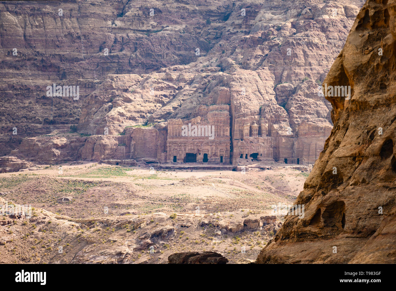 (Selective focus) Stunning view of a huge temple carved in stone framed by rocky mountain in the beautiful Petra site. Stock Photo