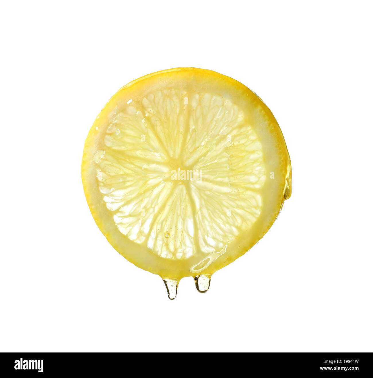 Essential oil dripping from lemon slice on white background Stock Photo