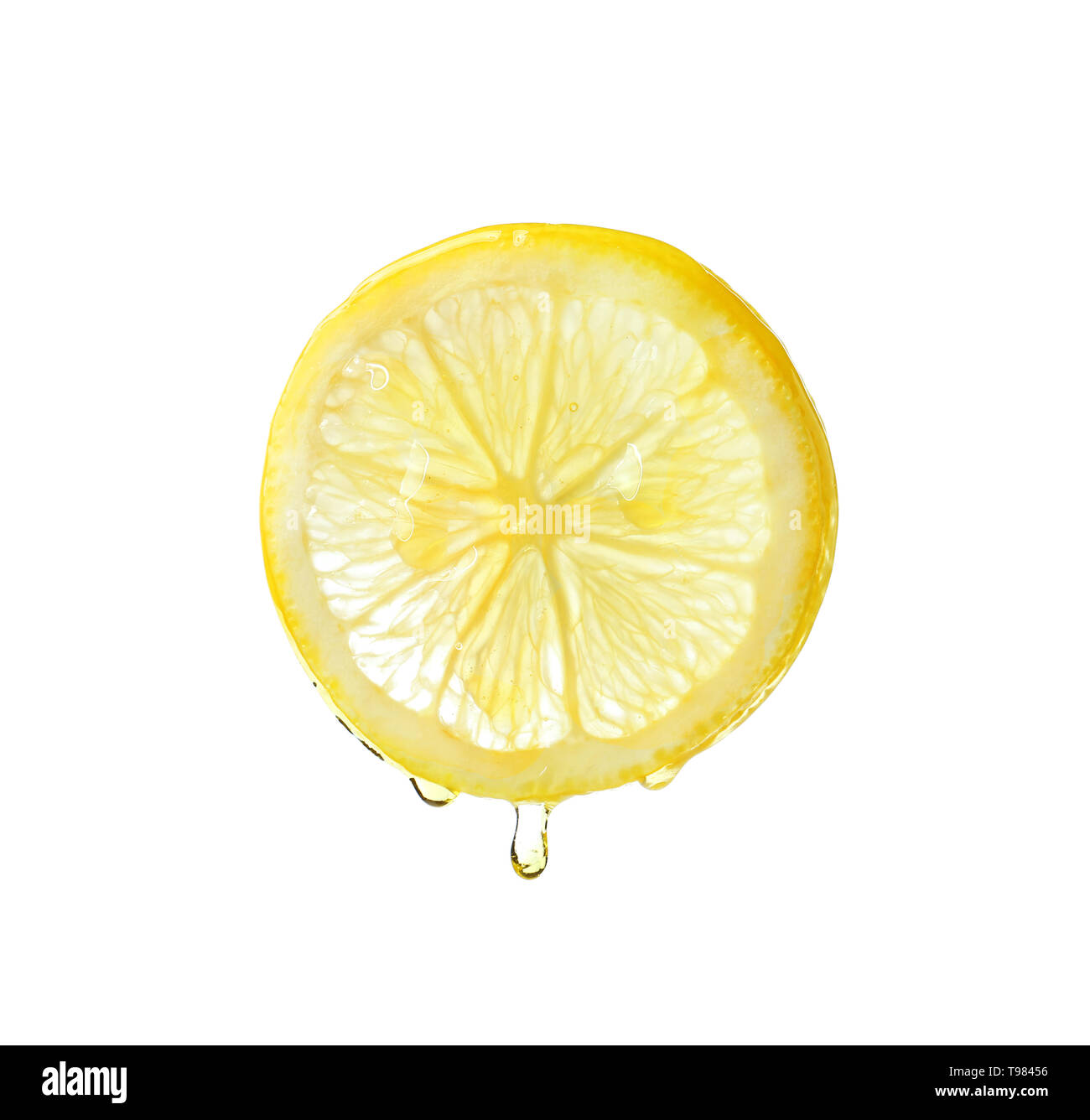 Essential oil dripping from lemon slice on white background Stock Photo