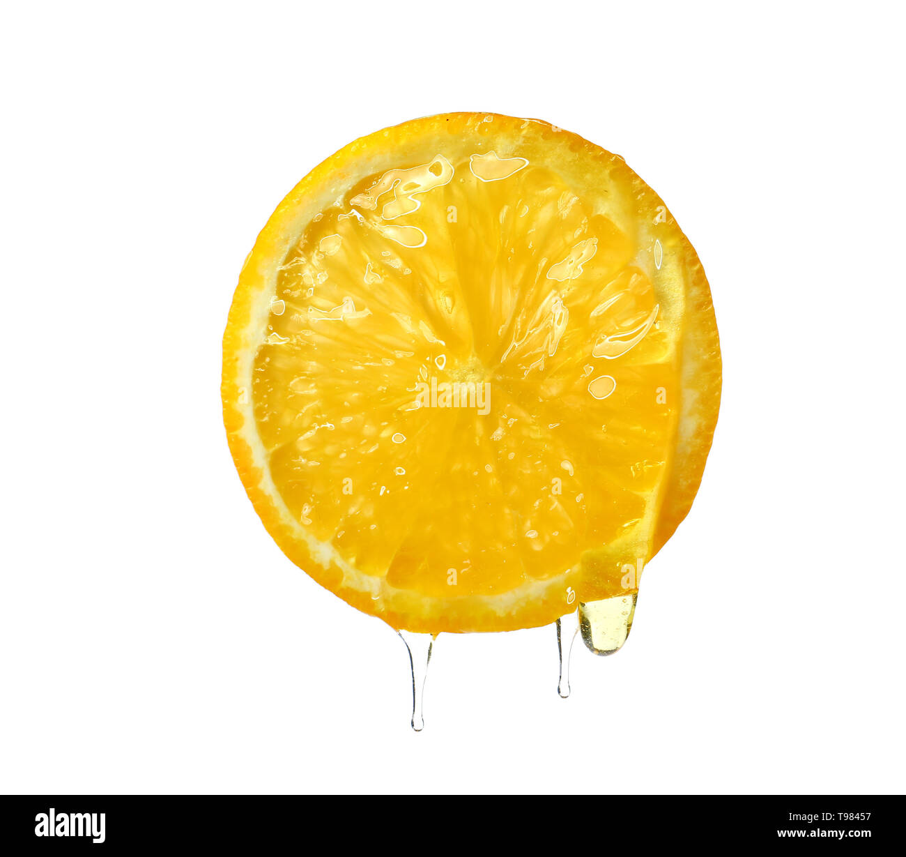 Essential oil dripping from orange slice on white background Stock Photo