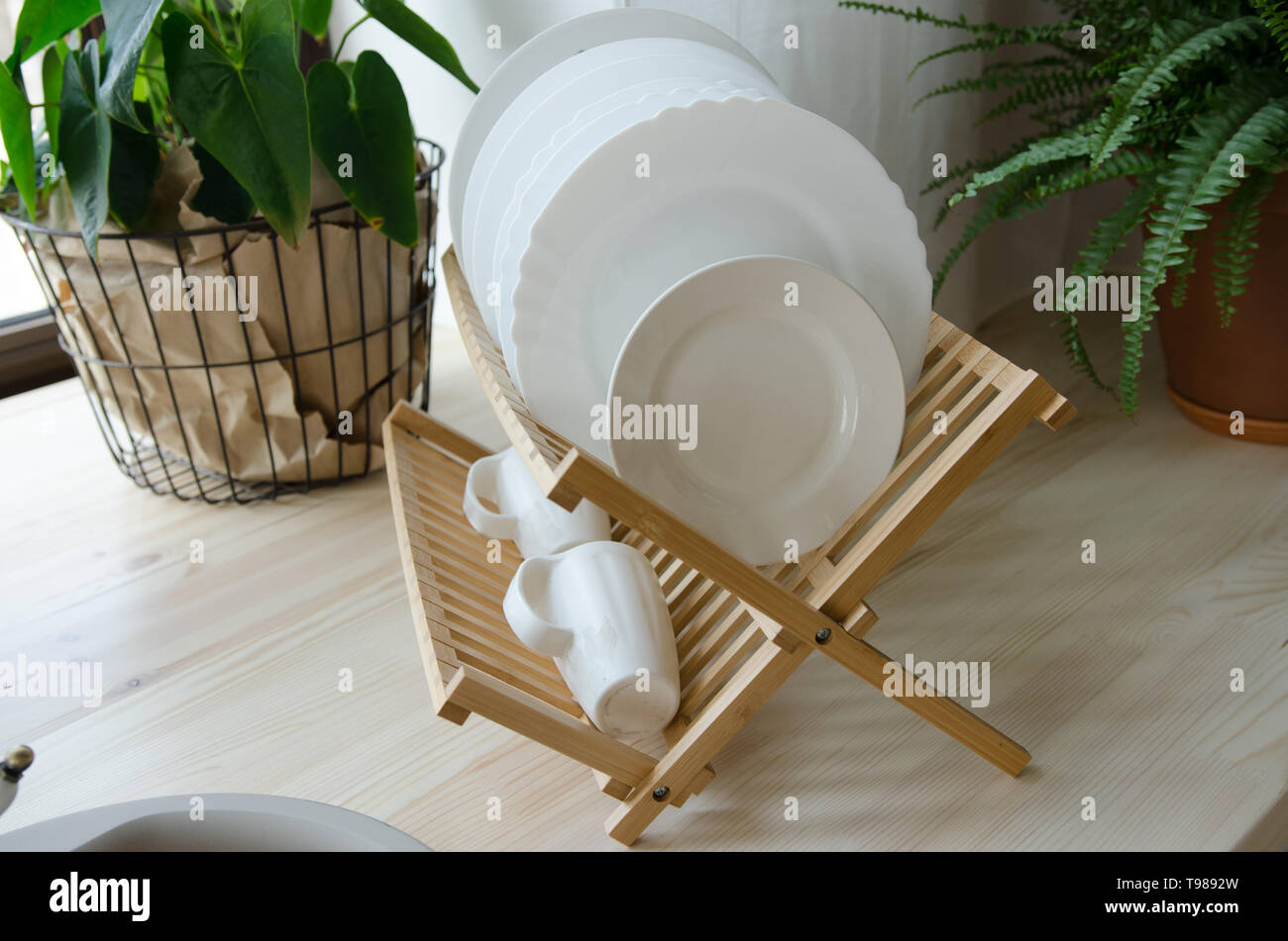 Clean dishes drying on wooden dish rack Stock Photo Alamy