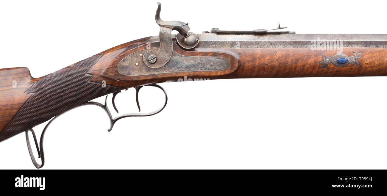 A percussion rifle, Siber in Lausanne, circa 1840 Heavy octagonal and finely grained Damascus barrel with bright bore, slightly rough at the muzzle and good groove/land profile in 16.5 mm calibre. On the top dovetailed front sight and adjustable rear sight and silver inlaid signature. Silver decorated patent breechblock with engraved tang. Colour case hardened percussion lock with en suite engraved and signed lockplate. Finely grained walnut half stock with partially blued, engraved furniture. Wooden ramrod with horn tip. Stock slightly bumped. L, Additional-Rights-Clearance-Info-Not-Available Stock Photo