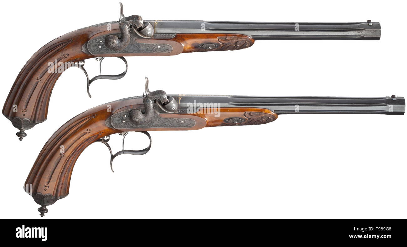 A cased pair of percussion pistols, Johann Springer in Vienna, circa 1850 Octagonal barrels with fluted middle section and original burnishing. Rifled bores in 9 mm calibre. Dovetailed, blued front sights, adjustable rear sights. The breeches with gold-inlaid signature 'J. Springer in Wien', the roots of the barrels decorated with gold-inlaid arabesques. The snails and tangs with deeply chiselled acanthus decoration. Barrels and tangs numbered '1' and '2', respectively. Locks decorated with fine, deeply etched tendrils and mythical creatures as w, Additional-Rights-Clearance-Info-Not-Available Stock Photo
