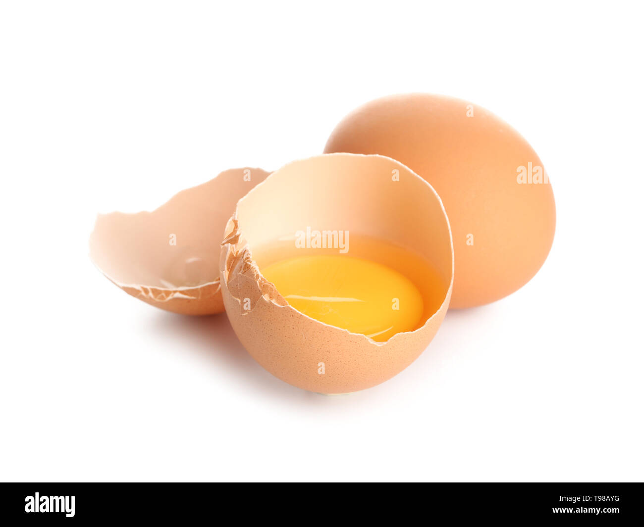 Cracked and whole chicken eggs on white background Stock Photo - Alamy