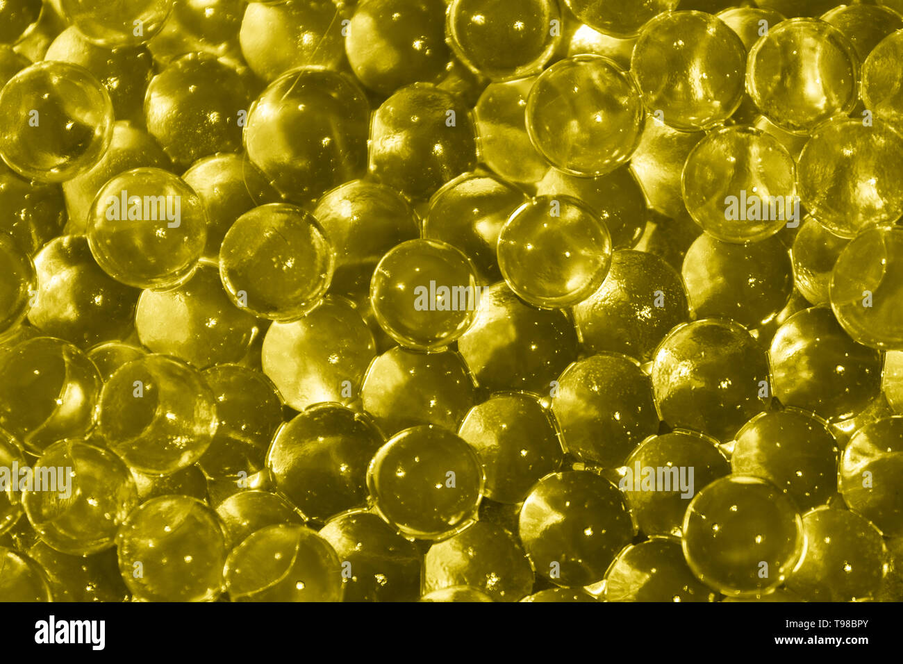 Transparent yellow hydrogel balls. Yellow water gel balls with bokeh